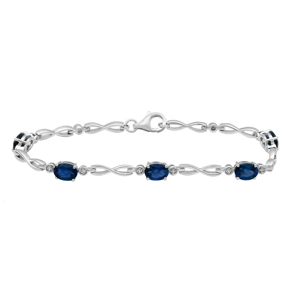 Jewelili Sterling Silver Oval Created Ceylon Sapphire Link Infinity Bracelet, 7.25"